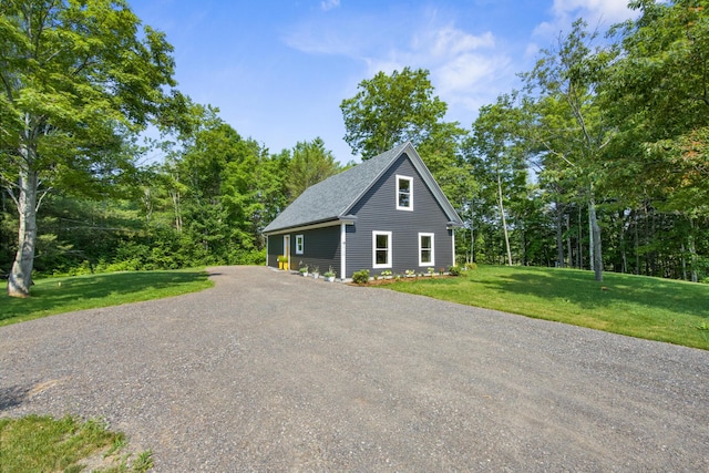 1719 Dixmont Rd, Etna, ME 04434 - view of side of home with a yard and a shingled roof