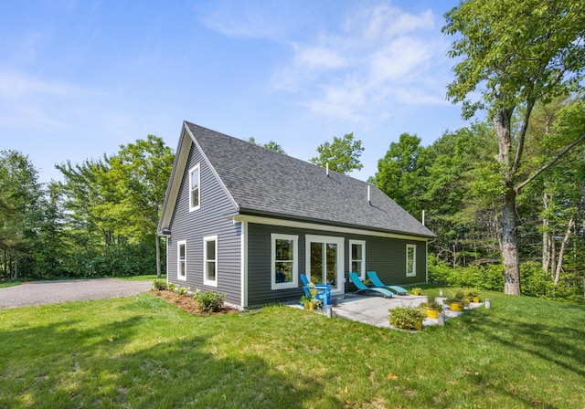 1719 Dixmont Rd, Etna, ME 04434 - rear view of house with a shingled roof, a lawn, and a patio area
