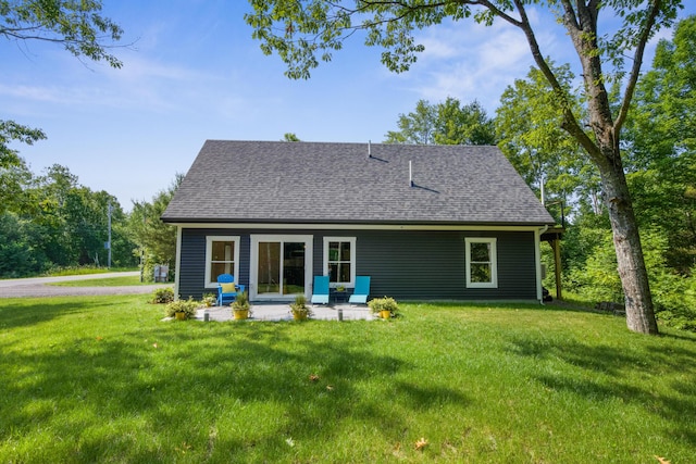 1719 Dixmont Rd, Etna, ME 04434 - back of property featuring a yard, a shingled roof, and a patio area