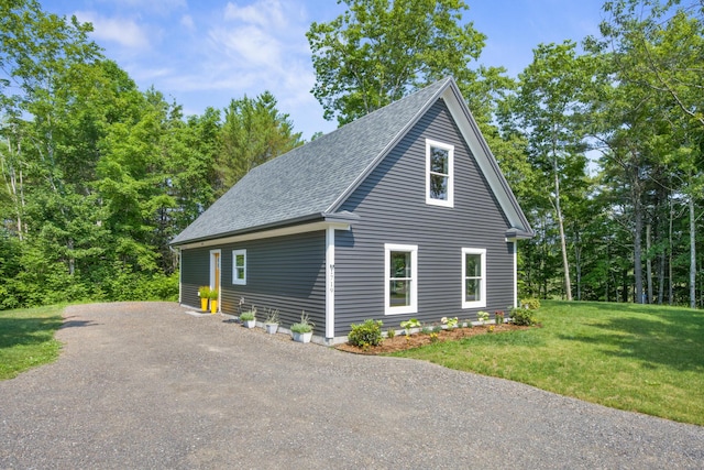 1719 Dixmont Rd, Etna, ME 04434 - view of side of property featuring a shingled roof and a yard