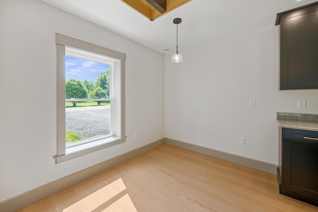 1719 Dixmont Rd, Etna, ME 04434 - unfurnished dining area with light wood-style floors and baseboards