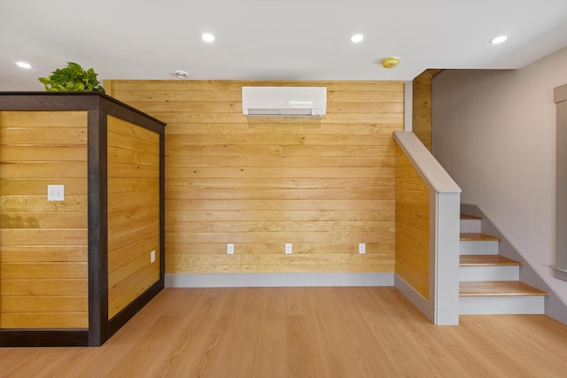1719 Dixmont Rd, Etna, ME 04434 - interior space featuring wood finished floors, an AC wall unit, wooden walls, stairs, and recessed lighting