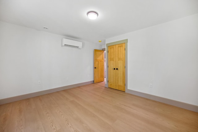 1719 Dixmont Rd, Etna, ME 04434 - empty room featuring a wall unit AC and light wood-style floors