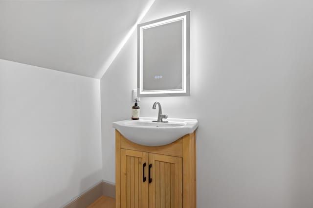 1719 Dixmont Rd, Etna, ME 04434 - bathroom with vaulted ceiling and vanity