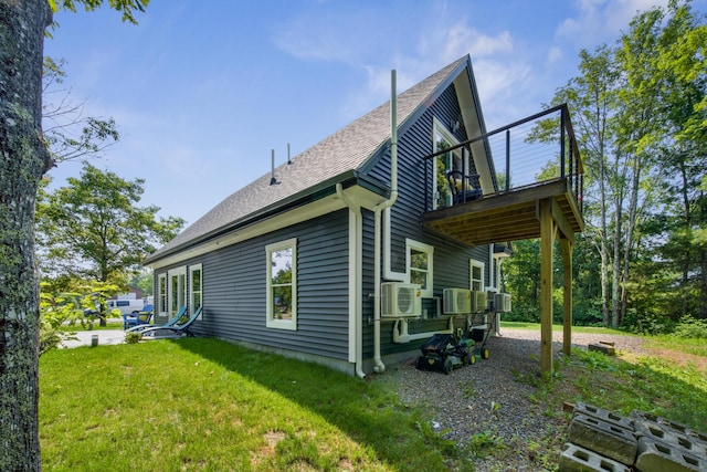 1719 Dixmont Rd, Etna, ME 04434 - rear view of house with a lawn, a shingled roof, and a balcony