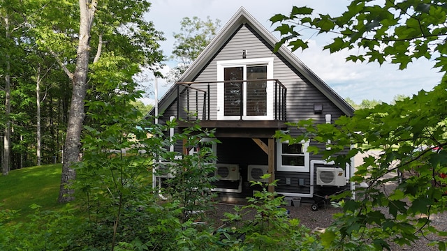 1719 Dixmont Rd, Etna, ME 04434 - rear view of property featuring a balcony, cooling unit, and a lawn