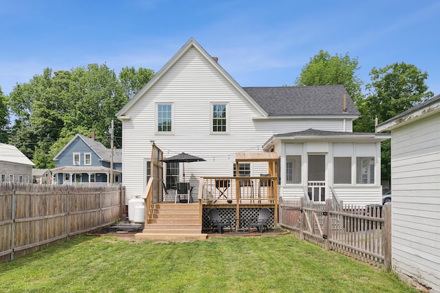 25 Searles St, Livermore Falls, ME 04254 - back of house featuring roof with shingles, a deck, a fenced backyard, and a sunroom