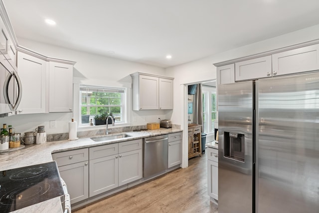 25 Searles St, Livermore Falls, ME 04254 - kitchen with appliances with stainless steel finishes, light wood-style flooring, light stone counters, and recessed lighting