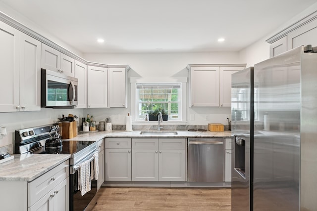 25 Searles St, Livermore Falls, ME 04254 - kitchen featuring appliances with stainless steel finishes, light stone countertops, recessed lighting, and light wood-type flooring