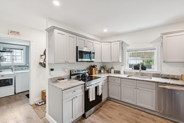 25 Searles St, Livermore Falls, ME 04254 - kitchen with stainless steel appliances, washer and dryer, healthy amount of natural light, light wood-type flooring, and recessed lighting