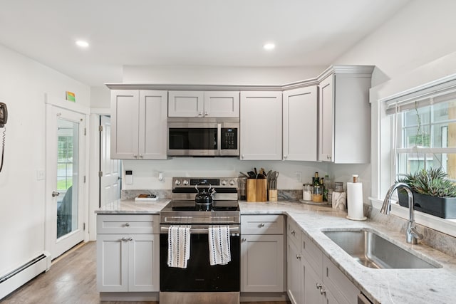 25 Searles St, Livermore Falls, ME 04254 - kitchen with stainless steel appliances, a baseboard radiator, gray cabinetry, light stone counters, and recessed lighting