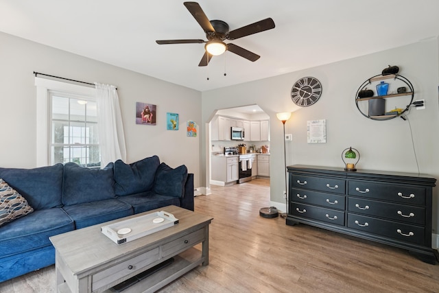 25 Searles St, Livermore Falls, ME 04254 - living area featuring ceiling fan, light wood finished floors, and arched walkways