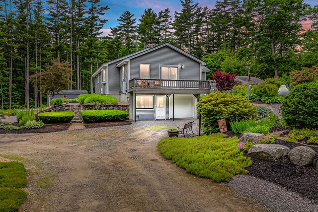 14 Old County Rd, South Berwick, ME 03908 - view of front facade with dirt driveway, a garage, and a deck