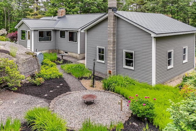 14 Old County Rd, South Berwick, ME 03908 - back of house featuring a fire pit, a chimney, and view of wooded area