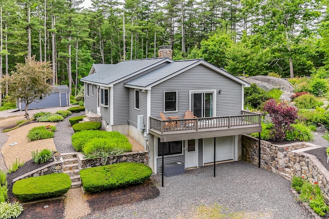 14 Old County Rd, South Berwick, ME 03908 - view of front facade with a chimney, a deck, gravel driveway, and a garage