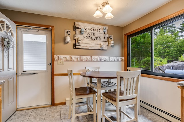 14 Old County Rd, South Berwick, ME 03908 - dining area with a baseboard radiator, a chandelier, and light tile patterned floors