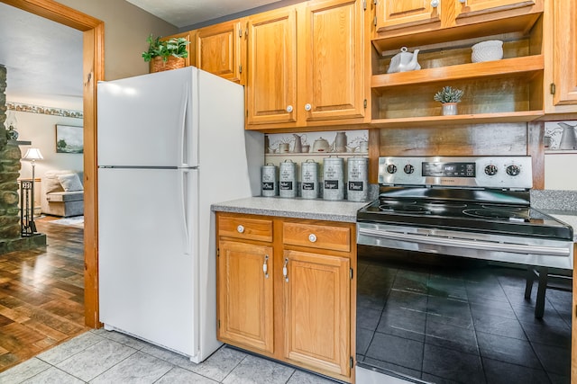 14 Old County Rd, South Berwick, ME 03908 - kitchen with stainless steel electric stove, freestanding refrigerator, open shelves, light countertops, and light tile patterned floors