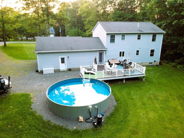 66 Stoney Acres Rd, Pittston, ME 04345 - rear view of property with a deck, a yard, view of wooded area, and an outdoor pool