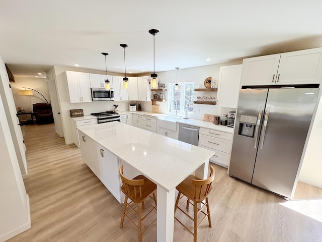 66 Stoney Acres Rd, Pittston, ME 04345 - kitchen featuring appliances with stainless steel finishes, light wood-type flooring, a center island, open shelves, and recessed lighting