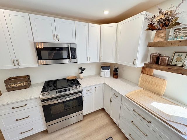 66 Stoney Acres Rd, Pittston, ME 04345 - kitchen featuring appliances with stainless steel finishes, white cabinetry, light wood-type flooring, light stone counters, and recessed lighting