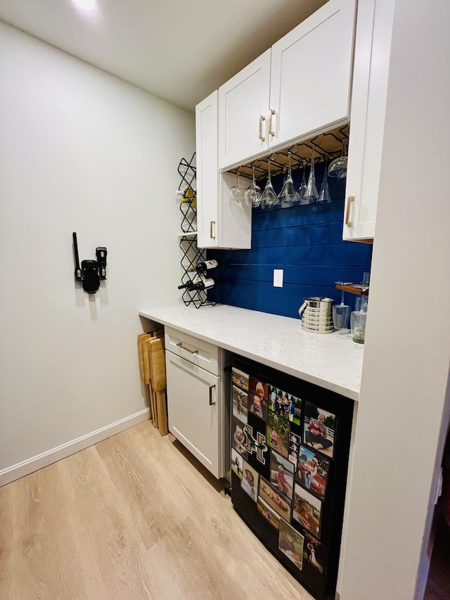 66 Stoney Acres Rd, Pittston, ME 04345 - indoor dry bar with light wood-style flooring and beverage cooler
