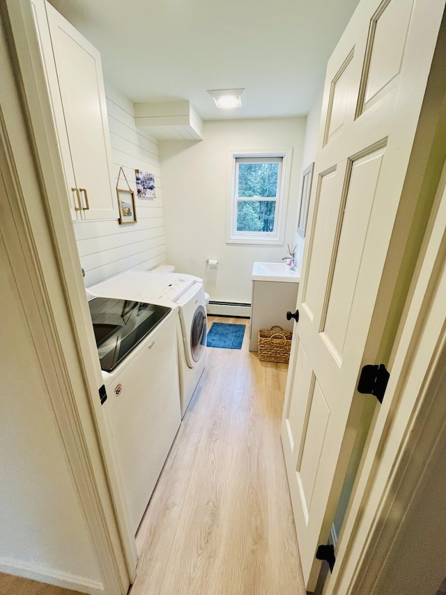 66 Stoney Acres Rd, Pittston, ME 04345 - washroom featuring a baseboard heating unit, separate washer and dryer, and light wood-style floors