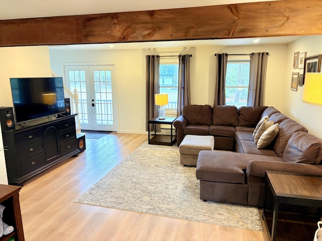 66 Stoney Acres Rd, Pittston, ME 04345 - living area with light wood finished floors, plenty of natural light, french doors, and a baseboard heating unit