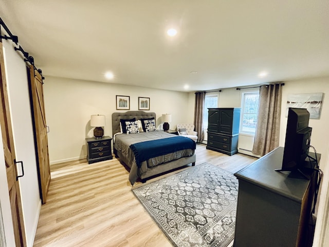 66 Stoney Acres Rd, Pittston, ME 04345 - bedroom featuring a barn door, light wood-type flooring, baseboard heating, and recessed lighting