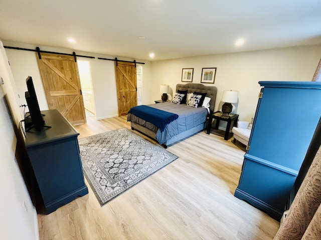 66 Stoney Acres Rd, Pittston, ME 04345 - bedroom featuring a barn door, light wood-type flooring, and recessed lighting