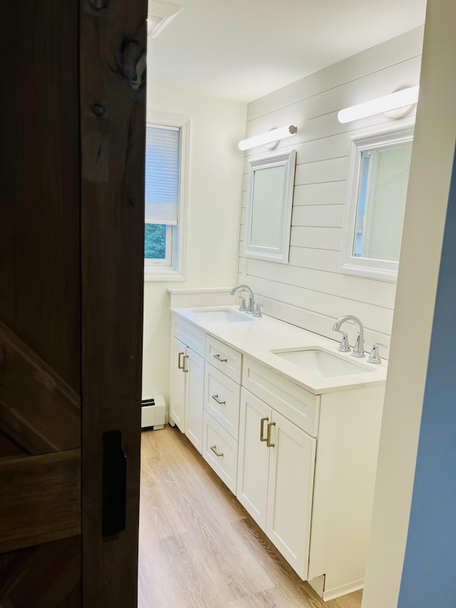 66 Stoney Acres Rd, Pittston, ME 04345 - full bath with baseboard heating, double vanity, and wood finished floors