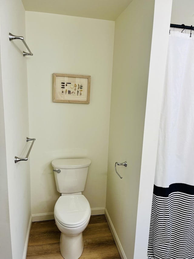 66 Stoney Acres Rd, Pittston, ME 04345 - bathroom with wood finished floors and a shower with shower curtain