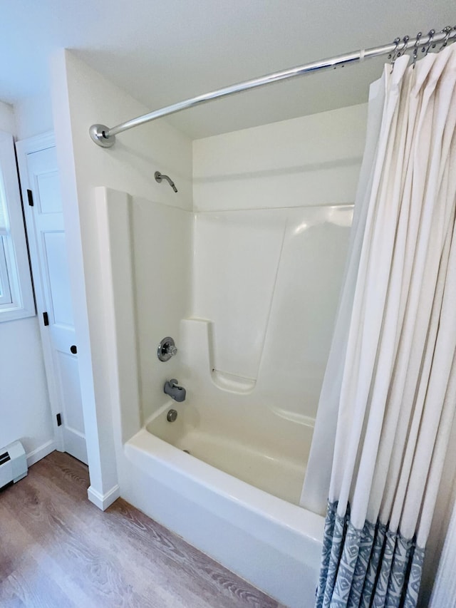 66 Stoney Acres Rd, Pittston, ME 04345 - full bathroom featuring wood finished floors and shower / tub combo with curtain