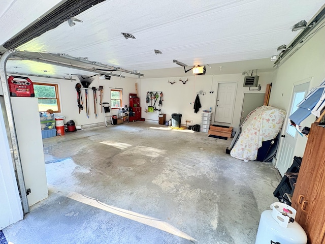 66 Stoney Acres Rd, Pittston, ME 04345 - garage featuring a garage door opener and a heating unit