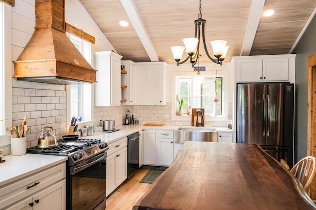 17 Green St, Dover-Foxcroft, ME 04426 - kitchen with stainless steel appliances, premium range hood, open shelves, butcher block counters, and a chandelier