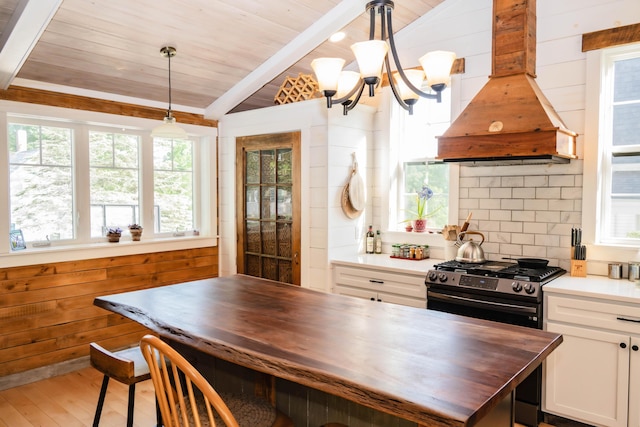 17 Green St, Dover-Foxcroft, ME 04426 - kitchen featuring butcher block countertops, premium range hood, stainless steel gas stove, wood ceiling, and a chandelier