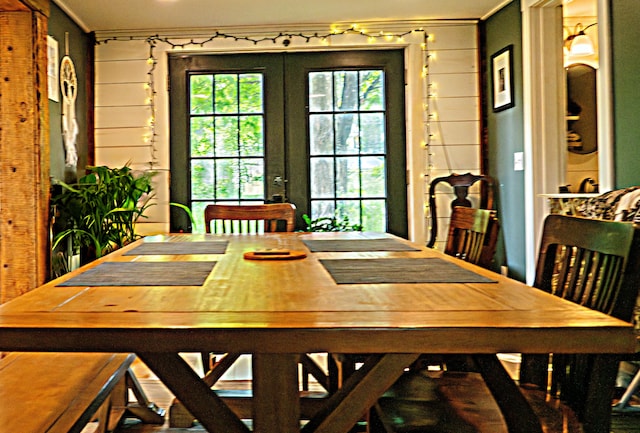 17 Green St, Dover-Foxcroft, ME 04426 - dining space with ornamental molding, french doors, and wooden walls