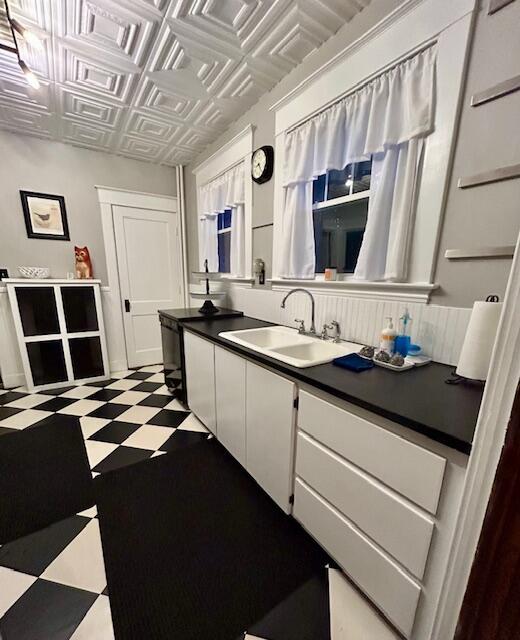 28 Holly St, Auburn, ME 04210 - kitchen featuring white cabinets, tile patterned floors, an ornate ceiling, and dark countertops