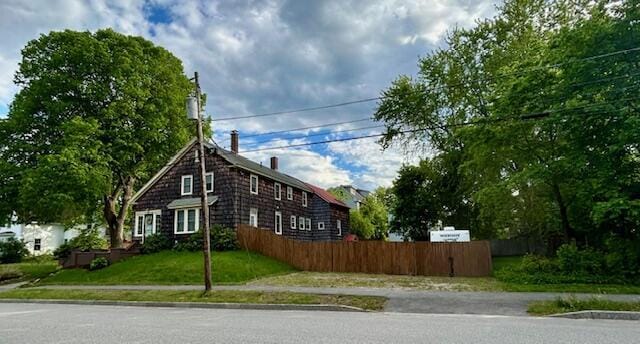 28 Holly St, Auburn, ME 04210 - view of home's exterior featuring a chimney