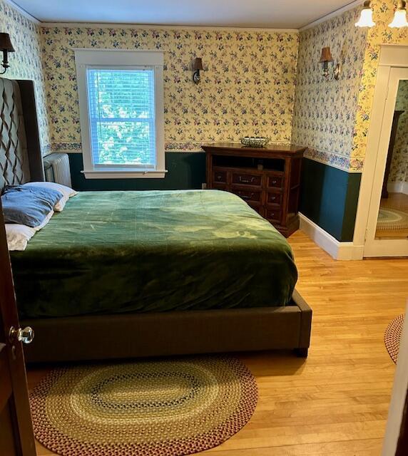 28 Holly St, Auburn, ME 04210 - bedroom featuring wallpapered walls, light wood finished floors, and crown molding