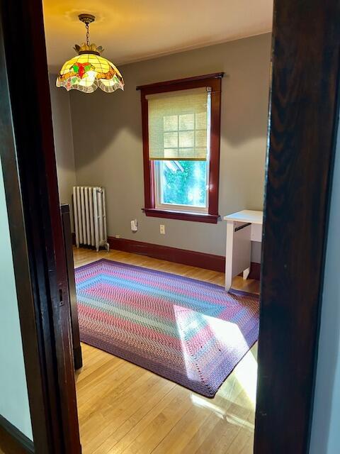 28 Holly St, Auburn, ME 04210 - spare room featuring radiator and wood finished floors