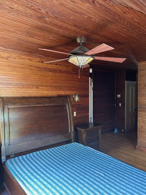 28 Holly St, Auburn, ME 04210 - unfurnished bedroom featuring wood ceiling, wood walls, wood finished floors, and a ceiling fan