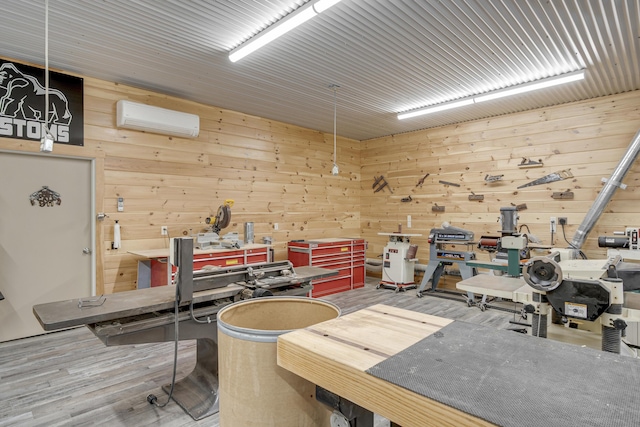 16 Keystone Spring Rd, Poland, ME 04274 - miscellaneous room featuring a wall mounted air conditioner, a workshop area, wood walls, and wood finished floors