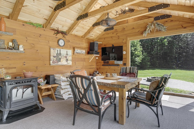 16 Keystone Spring Rd, Poland, ME 04274 - dining space with wooden walls, carpet flooring, a wood stove, and wooden ceiling