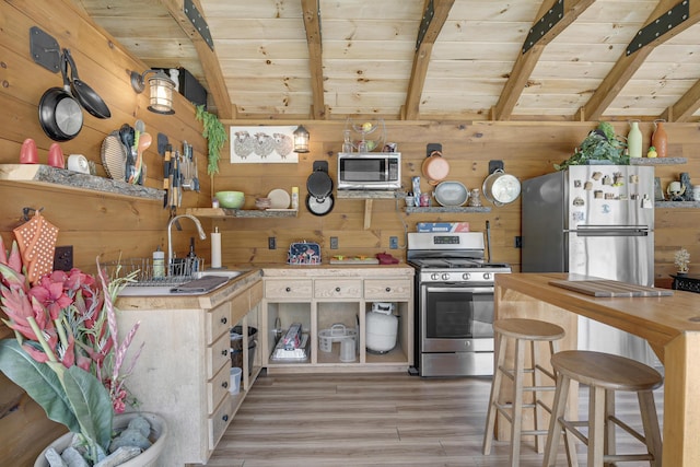 16 Keystone Spring Rd, Poland, ME 04274 - kitchen featuring appliances with stainless steel finishes, wood walls, wooden ceiling, butcher block countertops, and light wood finished floors