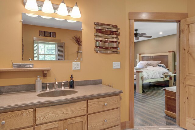 16 Keystone Spring Rd, Poland, ME 04274 - bathroom featuring vanity, a ceiling fan, wood finished floors, and ensuite bath