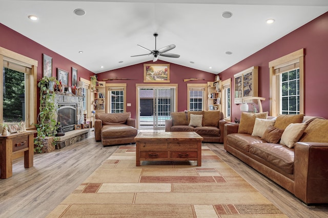 16 Keystone Spring Rd, Poland, ME 04274 - living room featuring light wood finished floors, lofted ceiling, a ceiling fan, a fireplace with raised hearth, and recessed lighting