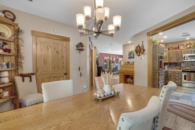 16 Keystone Spring Rd, Poland, ME 04274 - dining room featuring a chandelier, recessed lighting, bar area, and light wood finished floors