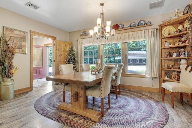 16 Keystone Spring Rd, Poland, ME 04274 - dining room with a chandelier, light wood-style flooring, and plenty of natural light