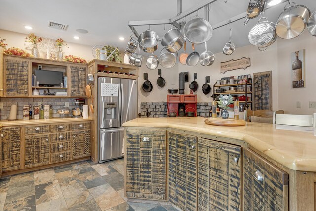 16 Keystone Spring Rd, Poland, ME 04274 - kitchen featuring stainless steel fridge, backsplash, light stone finish flooring, recessed lighting, and light countertops