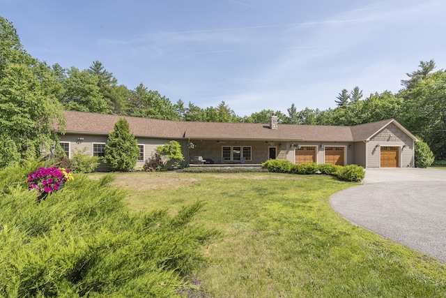 16 Keystone Spring Rd, Poland, ME 04274 - single story home with driveway, an attached garage, a front lawn, and a chimney